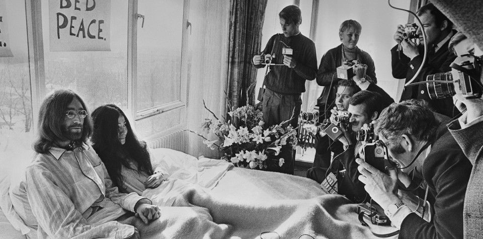 25th March 1969:  Beatles singer, songwriter and guitarist John Lennon and his wife of a week Yoko Ono receive the press at their bedside in the Presidential Suite of the Hilton Hotel, Amsterdam. The couple stayed in bed for seven days 'as a protest against war and violence in the world'.  (Photo by Central Press/Getty Images)